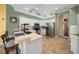 Well-appointed kitchen featuring stainless steel appliances, white cabinets, tile floors, and a convenient breakfast bar at 3542 Conifer Loop, Spring Hill, FL 34609