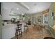 Bright and open kitchen with a breakfast bar, adjacent dining area, and seamless flow to the rest of the home at 3542 Conifer Loop, Spring Hill, FL 34609
