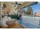 Relaxing screened lanai with a ceiling fan, wet bar, grill, and comfortable seating area by the pool at 3542 Conifer Loop, Spring Hill, FL 34609