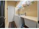 A well-lit laundry room with modern appliances, storage shelves, and a folding counter at 3542 Conifer Loop, Spring Hill, FL 34609
