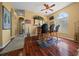 Cozy living room featuring a classic bar setup, hardwood floors, and bright windows at 3542 Conifer Loop, Spring Hill, FL 34609