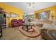 Bright living room with comfortable seating, hardwood floors, and a view into the kitchen, perfect for entertaining and relaxing at 3542 Conifer Loop, Spring Hill, FL 34609