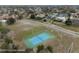 Aerial view of a well-maintained blue and green community tennis court at 3542 Conifer Loop, Spring Hill, FL 34609