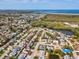An aerial view of a charming neighborhood shows mature trees and a waterway in the distance at 3730 Sail Dr, New Port Richey, FL 34652