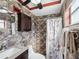 Cozy bathroom featuring stone-like walls, dark vanity, and shower with patterned curtain at 3730 Sail Dr, New Port Richey, FL 34652