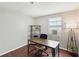 Well-lit bedroom with wood-look floors, a window AC unit, and a stylish industrial shelving unit at 3730 Sail Dr, New Port Richey, FL 34652