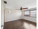 Bright bedroom features modern ceiling fan, hardwood floors, and large window with backyard view at 3730 Sail Dr, New Port Richey, FL 34652