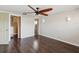 Spacious bedroom with wood floors, ceiling fan, and organized walk-in closet at 3730 Sail Dr, New Port Richey, FL 34652
