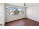 Bright, airy bedroom with large picture window and warm hardwood floors at 3730 Sail Dr, New Port Richey, FL 34652