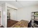 Bright bedroom featuring wood-look floors, mirrored closet and a modern shelving unit at 3730 Sail Dr, New Port Richey, FL 34652