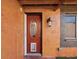 Charming front door with an oval window, pet door and stucco walls at 3730 Sail Dr, New Port Richey, FL 34652