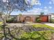 Charming single-story home featuring a lawn, arched entryway and an attached orange garage at 3730 Sail Dr, New Port Richey, FL 34652