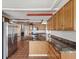 Well-lit kitchen with stainless steel refrigerator and dark marble countertops and backsplash at 3730 Sail Dr, New Port Richey, FL 34652