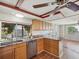 Kitchen boasts custom wood cabinetry, stainless steel appliances, granite countertops, and natural light at 3730 Sail Dr, New Port Richey, FL 34652