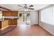 Eat-in kitchen featuring custom wood cabinetry, a stainless refrigerator, and access to the backyard at 3730 Sail Dr, New Port Richey, FL 34652