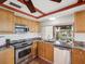 Bright kitchen with stainless steel appliances, granite countertops, and custom wood cabinets at 3730 Sail Dr, New Port Richey, FL 34652