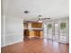 This living room is connected to an eat-in kitchen area with red tiling and a view of the outdoor patio at 3730 Sail Dr, New Port Richey, FL 34652