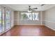 Sunny living room featuring large windows, neutral paint, and terra cotta tile flooring at 3730 Sail Dr, New Port Richey, FL 34652