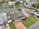 Aerial view of a home featuring a well-kept lawn, canal access, and a private dock at 4048 Orient Dr, Hernando Beach, FL 34607