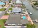 Aerial view of a canal front home with a pool, dock, and outdoor entertainment area at 4048 Orient Dr, Hernando Beach, FL 34607