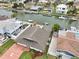 Aerial view of home with a manicured lawn, canal access, and private dock, ideal for boaters at 4048 Orient Dr, Hernando Beach, FL 34607