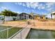 Backyard features private dock, waterfront access, screened-in porch, and patio area, ideal for outdoor entertaining at 4048 Orient Dr, Hernando Beach, FL 34607