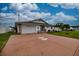 Single Gathering home features stone accents, a large driveway, and well-maintained front yard at 4048 Orient Dr, Hernando Beach, FL 34607