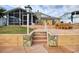 Rear exterior of the home showcasing well-kept patio, landscaping and stone chimney at 4048 Orient Dr, Hernando Beach, FL 34607