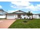 Charming single-story home featuring a well-maintained lawn, attached garage and stone accented entrance at 4048 Orient Dr, Hernando Beach, FL 34607