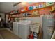 Functional laundry room with washer, dryer, and ample shelving for storage solutions at 4048 Orient Dr, Hernando Beach, FL 34607