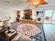 Inviting living room with stone fireplace, ceiling fan, and access to the outdoor patio at 4048 Orient Dr, Hernando Beach, FL 34607