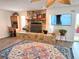 Bright living room featuring a stone fireplace, wood floors, and a ceiling fan at 4048 Orient Dr, Hernando Beach, FL 34607