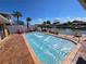 Backyard pool, with a gazebo and waterfront canal access, red brick patio, and privacy fence at 4048 Orient Dr, Hernando Beach, FL 34607