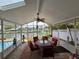 The sunroom has an inviting table, skylights, and views of the pool and waterway at 4048 Orient Dr, Hernando Beach, FL 34607