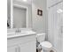 Bright bathroom featuring a white vanity, toilet, and a glass-enclosed shower at 4062 Maurice Ave, Odessa, FL 33556