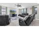 Comfortable living room with dark, reclining leather seating and a ceiling fan at 4062 Maurice Ave, Odessa, FL 33556