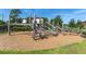 Unique wooden playground structure with climbing features and a rope net on a wood chip surface at 4062 Maurice Ave, Odessa, FL 33556