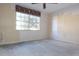 Bedroom features a large window providing natural light and bare walls at 4707 Wallingford Ct # 4707, New Port Richey, FL 34655