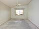 Empty bedroom features a ceiling fan and a window with natural light at 4707 Wallingford Ct # 4707, New Port Richey, FL 34655
