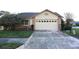 Charming single-story home featuring a brick facade and a two-car garage at 4707 Wallingford Ct # 4707, New Port Richey, FL 34655