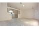 A spacious living room with a large window, ceiling fan and a side door at 4707 Wallingford Ct # 4707, New Port Richey, FL 34655