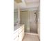 Bathroom featuring a glass door shower and a sink with a white countertop and cabinets at 4707 Wallingford Ct # 4707, New Port Richey, FL 34655