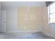Empty bedroom with light walls, a window, and a door, with a stained concrete floor at 4707 Wallingford Ct # 4707, New Port Richey, FL 34655