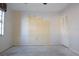 Empty bedroom with light walls, a window, and a door, with a stained concrete floor at 4707 Wallingford Ct # 4707, New Port Richey, FL 34655