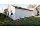 View of the exterior of a home, featuring a stucco wall and green grass at 4707 Wallingford Ct # 4707, New Port Richey, FL 34655
