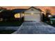 Home featuring well-maintained garage and nice landscaping under an evening sky at 4707 Wallingford Ct # 4707, New Port Richey, FL 34655