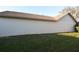 View of the exterior of a home, featuring a stucco wall and green grass at 4707 Wallingford Ct # 4707, New Port Richey, FL 34655