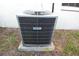HVAC unit is placed on the green grass outside of the white stucco home at 4707 Wallingford Ct # 4707, New Port Richey, FL 34655