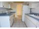 Functional kitchen layout with white cabinets and updated appliances offering a practical cooking space at 4707 Wallingford Ct # 4707, New Port Richey, FL 34655