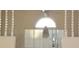 Bright living room featuring a large window with blinds and decorative columns at 4707 Wallingford Ct # 4707, New Port Richey, FL 34655